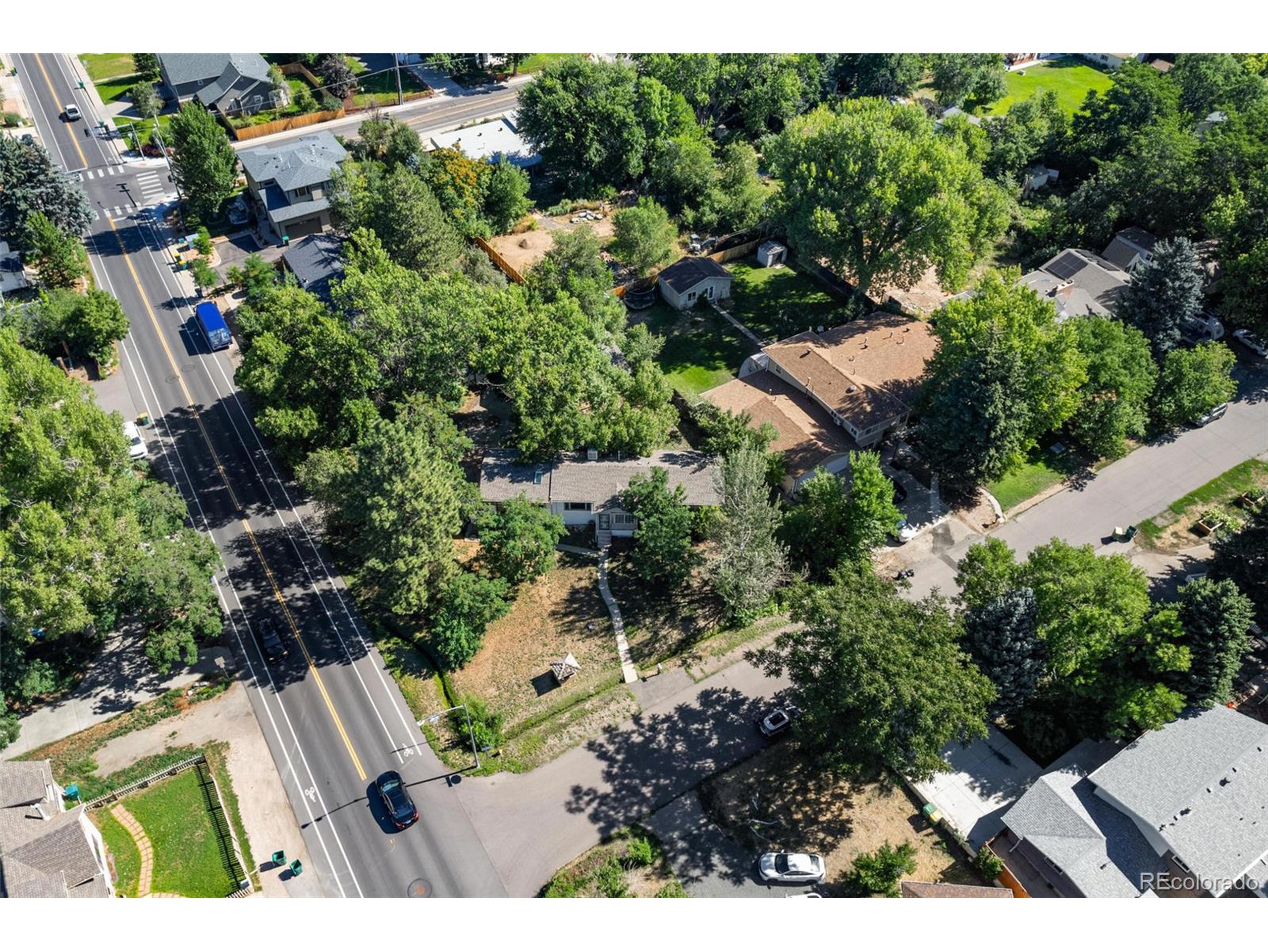 6795 West 31st Avenue Wheat Ridge, CO 80214 - Photo 26 of 35 an aerial view of residential house with outdoor space and trees all around