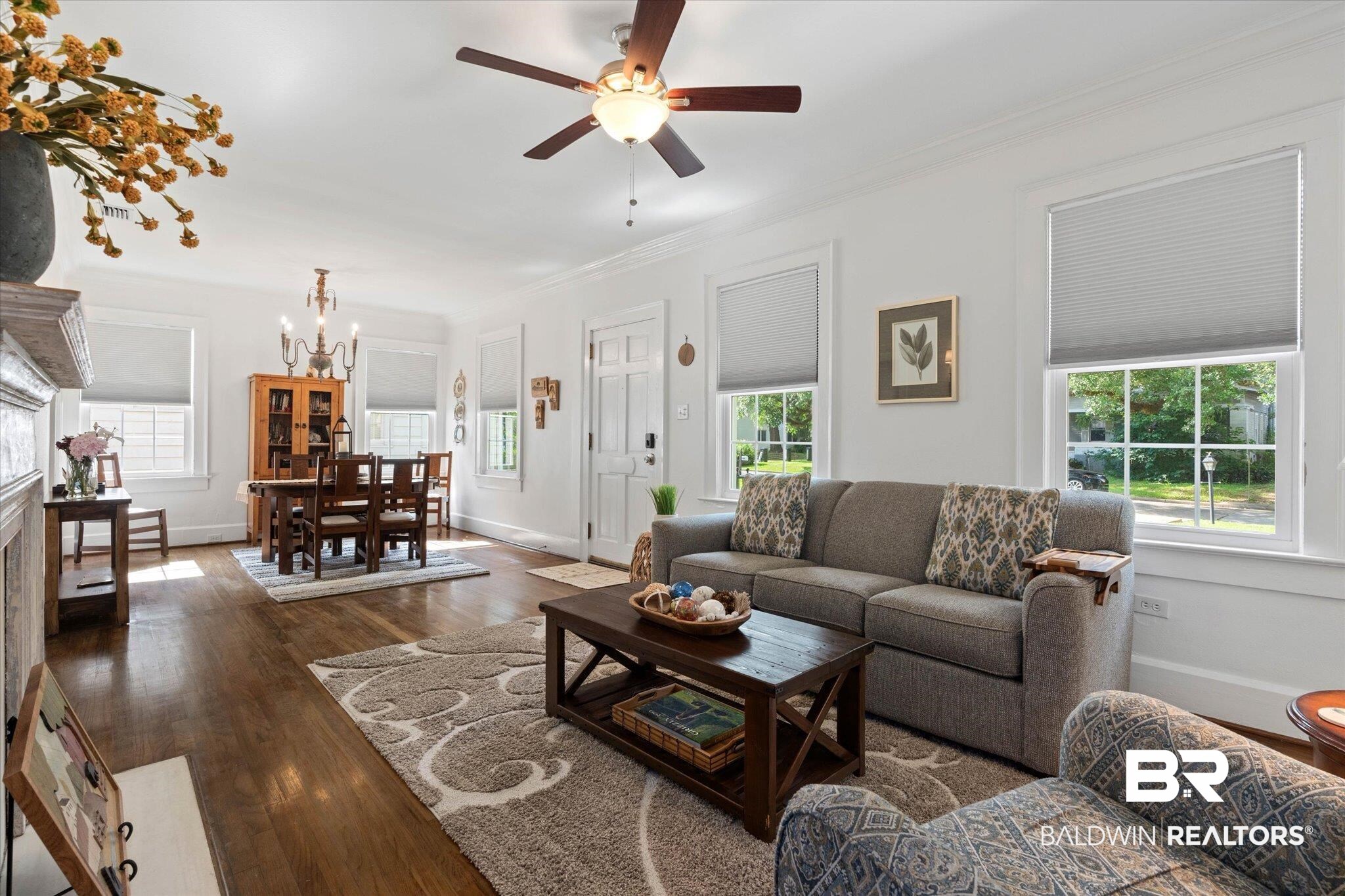 1910 Hunter Avenue Mobile, AL 36606 - Photo 2 of 21 Living room featuring a chandelier, a ceiling fan, ornamental molding, dark wood-style floors, and baseboards