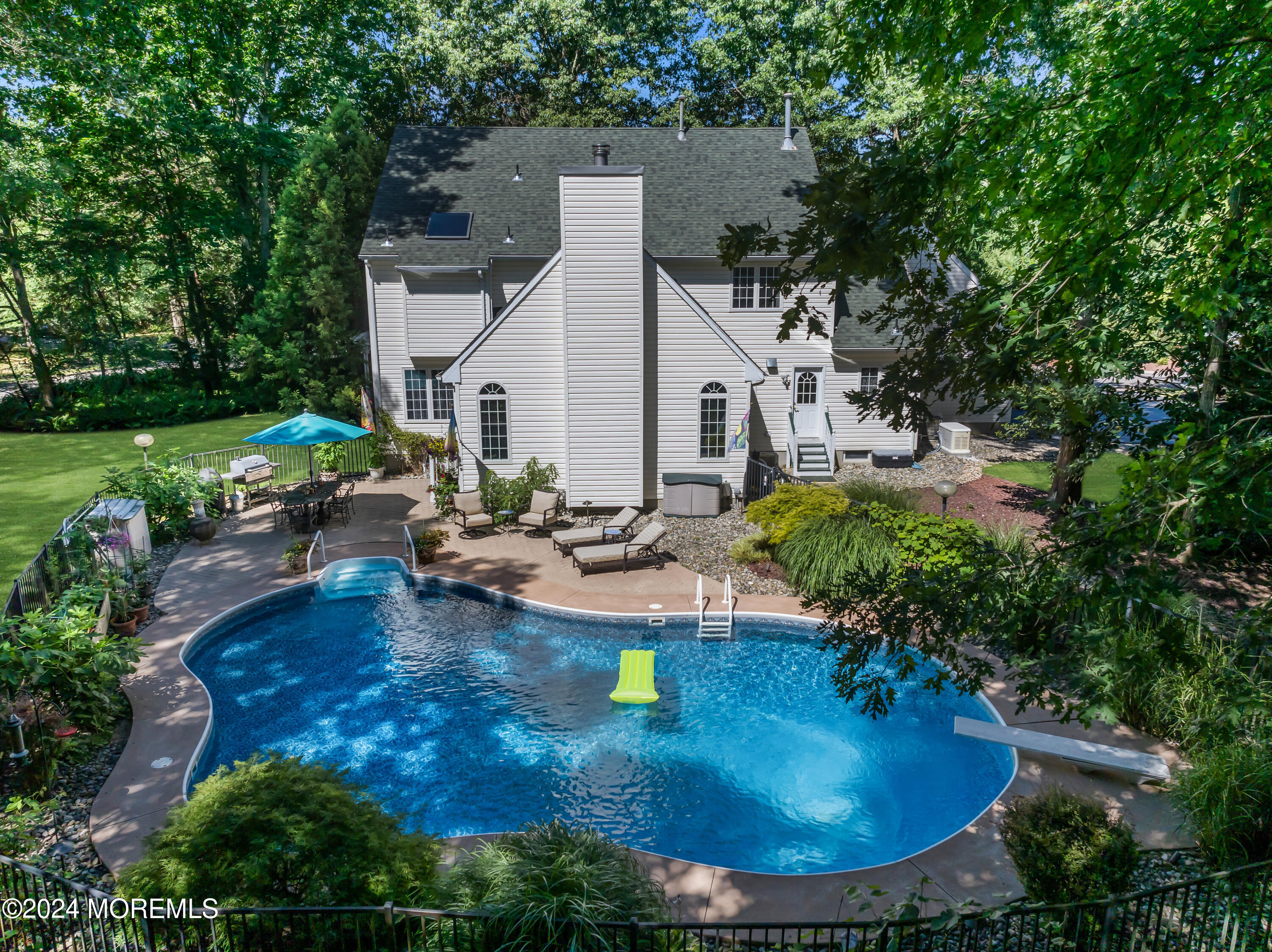 11 Dunhill Road Jackson, NJ 08527 - Photo 138 of 147 a view of a backyard with table and chairs potted plants and large tree