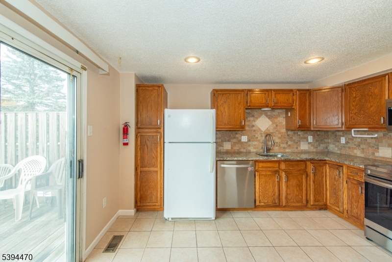 8 Constitution Way Franklin, NJ 07416 - Photo 11 of 26 a kitchen with stainless steel appliances granite countertop a refrigerator and a sink