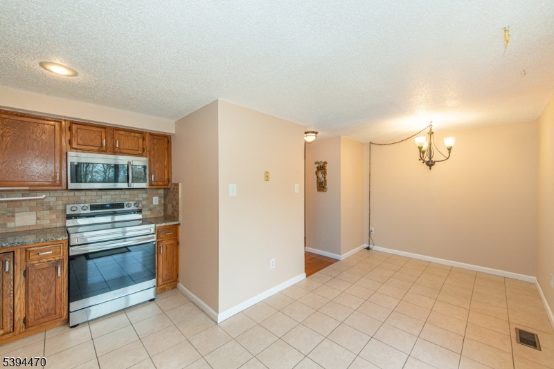 8 Constitution Way Franklin, NJ 07416 - Photo 14 of 26 a kitchen with white cabinets and appliances