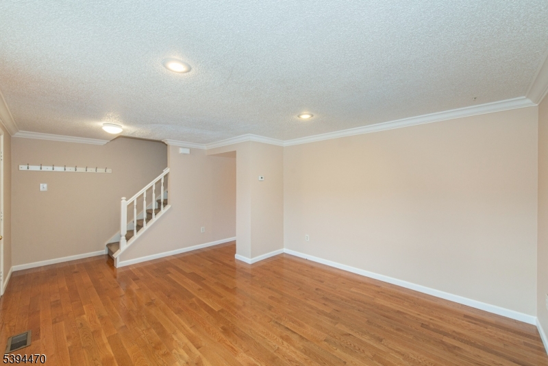 8 Constitution Way Franklin, NJ 07416 - Photo 5 of 26 a view of an empty room with wooden floor