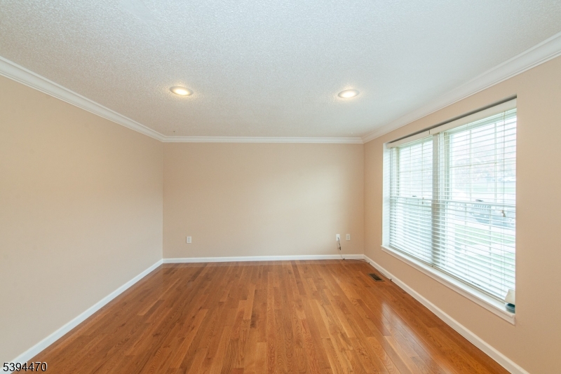 8 Constitution Way Franklin, NJ 07416 - Photo 7 of 26 wooden floor in an empty room with a window