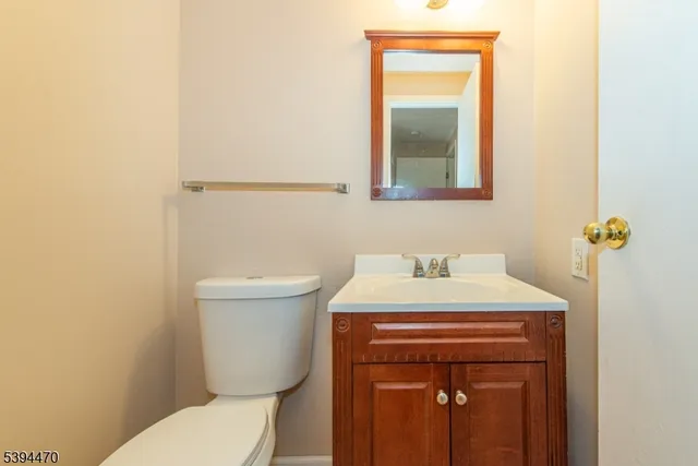 a bathroom with a sink a toilet and mirror