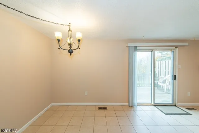 a view of a room with an empty space and a window