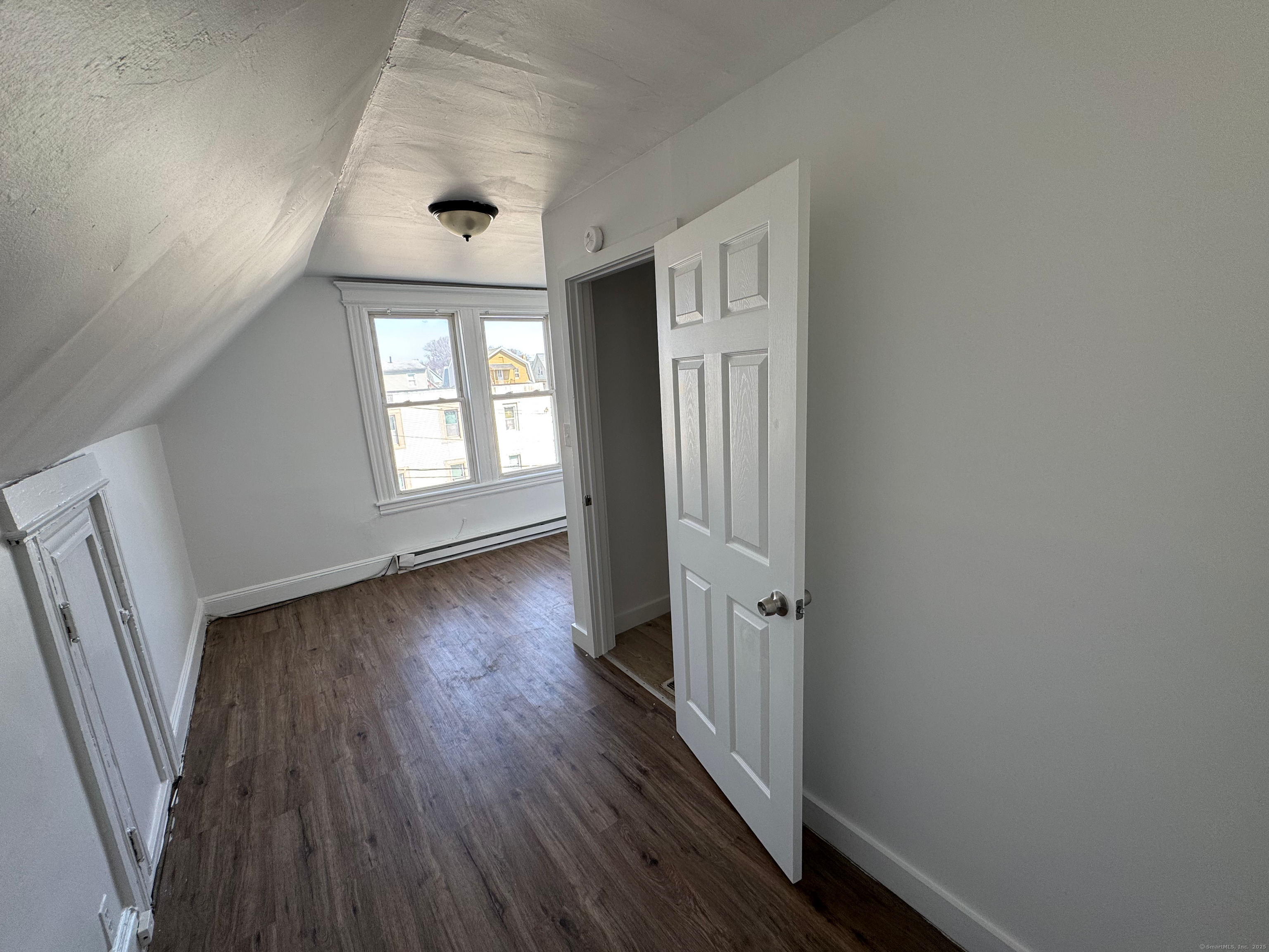 10 Beatrice Street, Unit 3 Bridgeport, CT 06607 - Photo 11 of 12 an empty room with wooden floor and a window