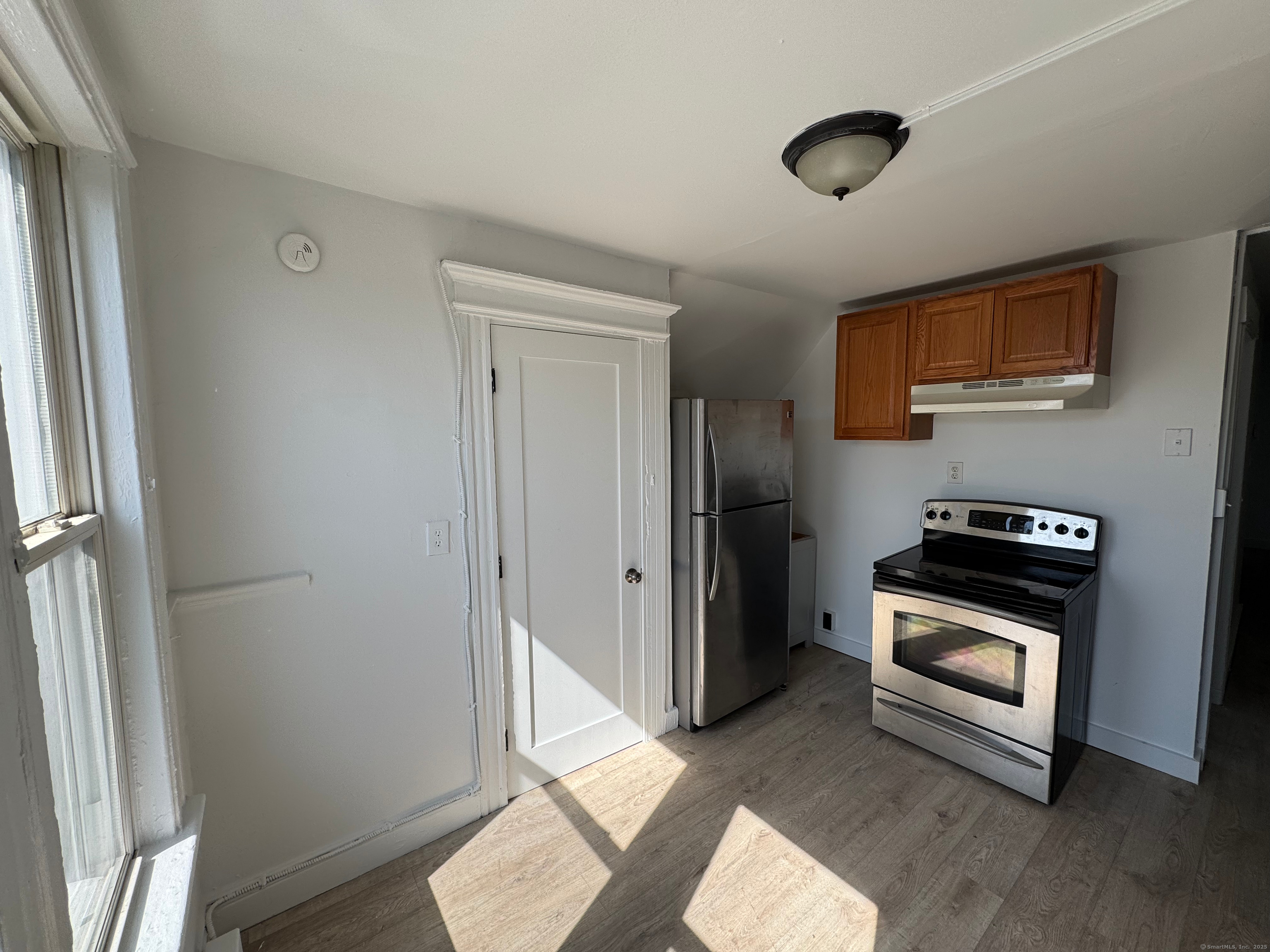 10 Beatrice Street, Unit 3 Bridgeport, CT 06607 - Photo 2 of 12 a kitchen with a refrigerator and a stove top oven