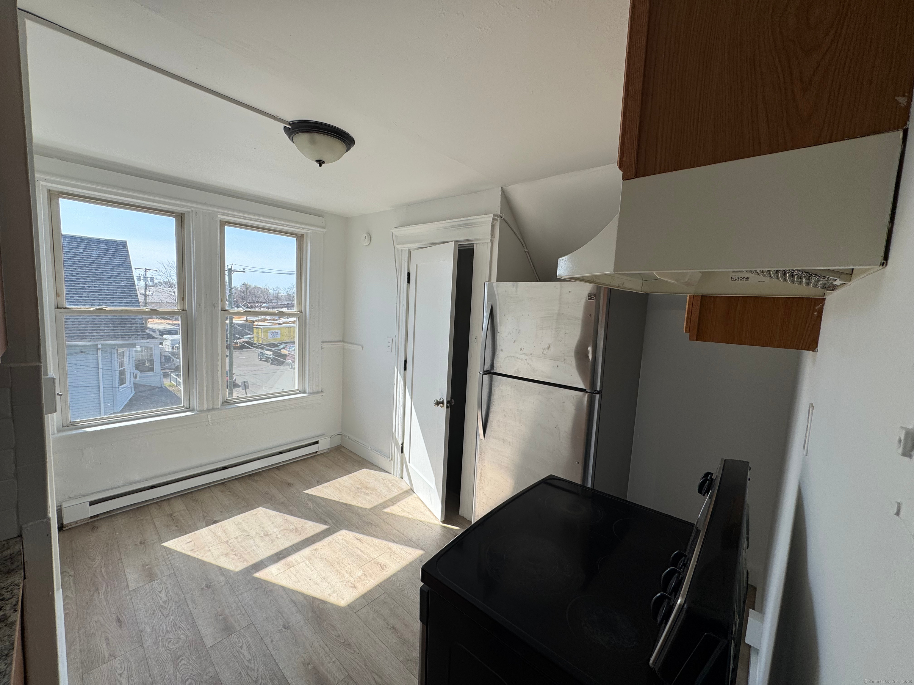 10 Beatrice Street, Unit 3 Bridgeport, CT 06607 - Photo 3 of 12 a kitchen with a refrigerator and window