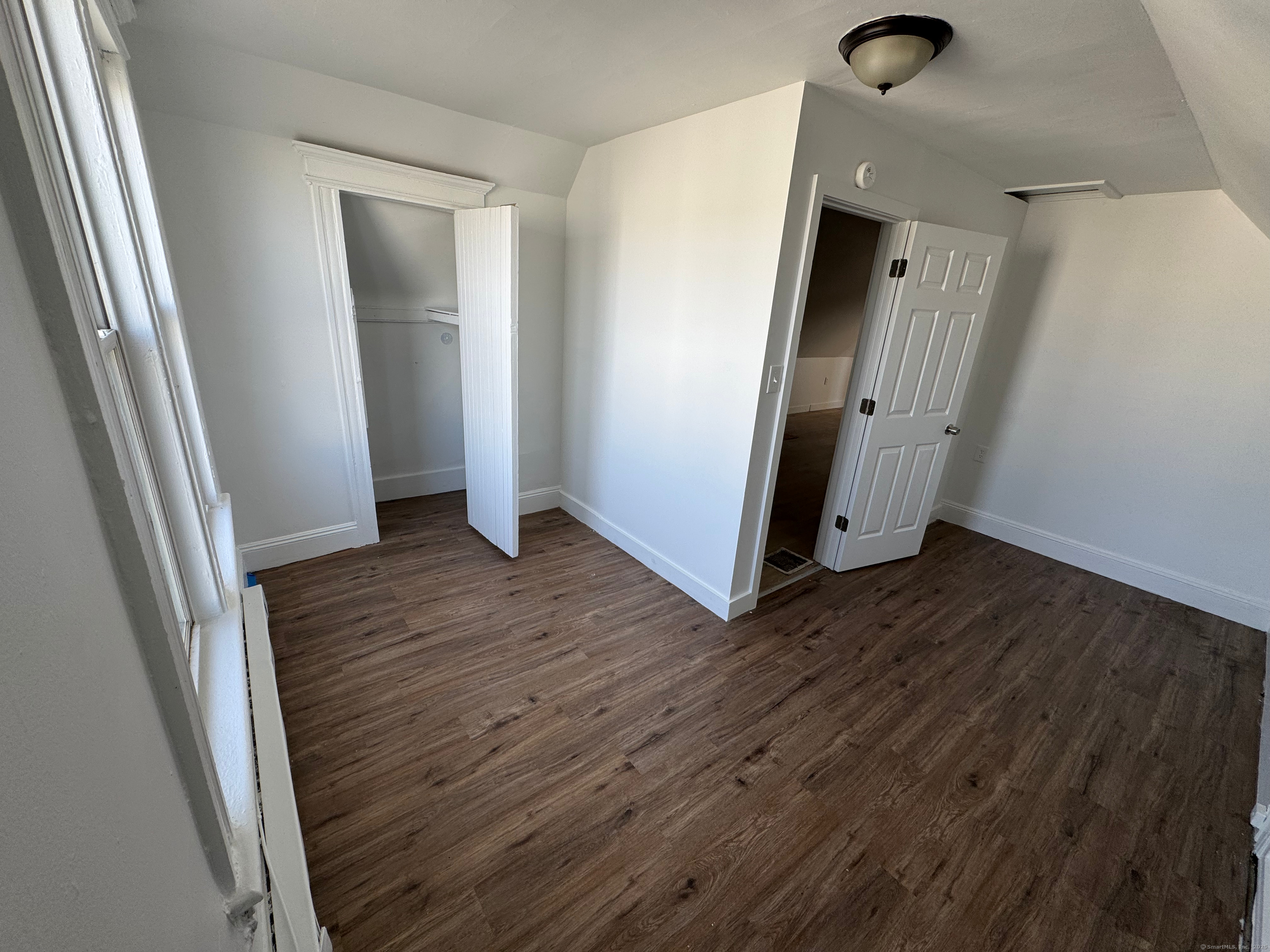 10 Beatrice Street, Unit 3 Bridgeport, CT 06607 - Photo 9 of 12 an empty room with wooden floor and entrance