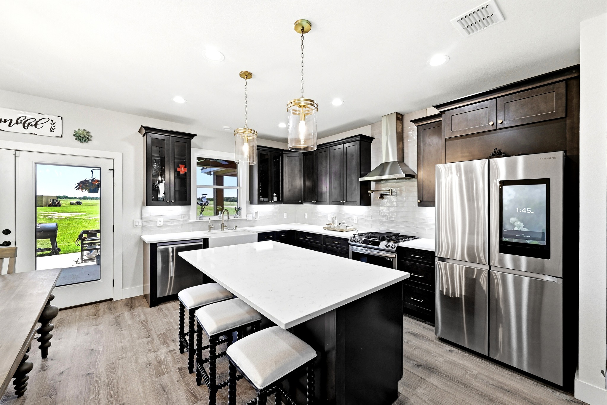 2889 Old McMahan Road Lockhart, TX 78644 - Photo 15 of 33 A gourmet kitchen offers a spacious island, custom cabinetry, and premium appliances perfect for culinary creations.
