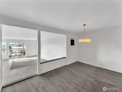 a kitchen with stainless steel appliances granite countertop a refrigerator a sink a stove and a wooden floors