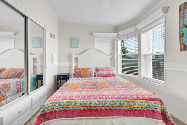 a bedroom with a bed and a painting on the wall