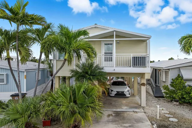 an aerial view of a house with a ocean view