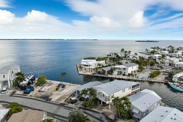 an aerial view of a house with a ocean view