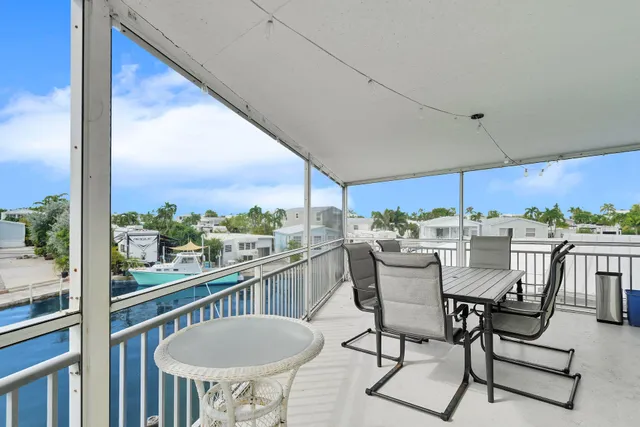 a view of a balcony with chairs and a table