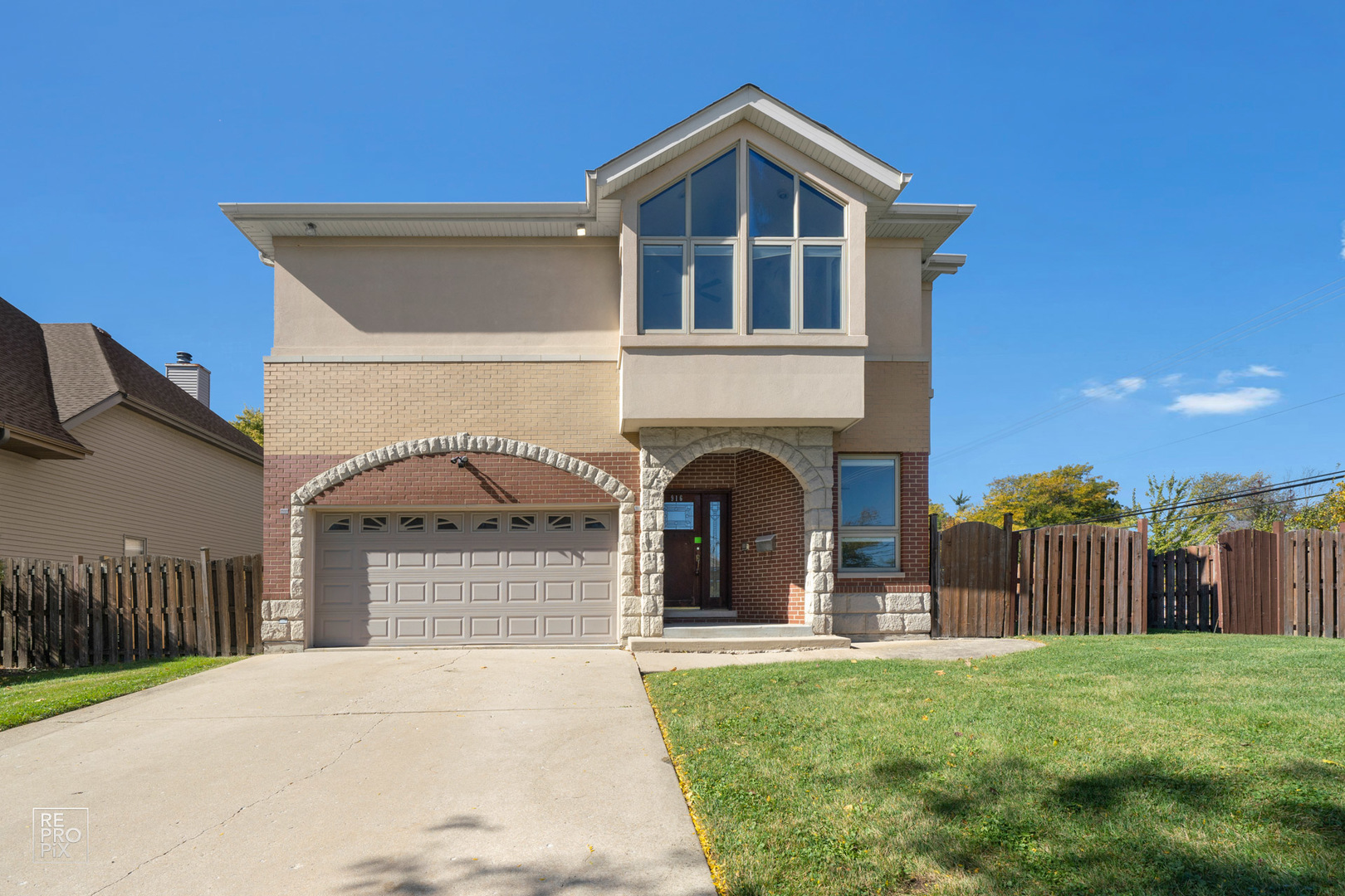 916 Elmdale Road Glenview, IL 60025 - Photo 1 of 20 a front view of a house with a garden