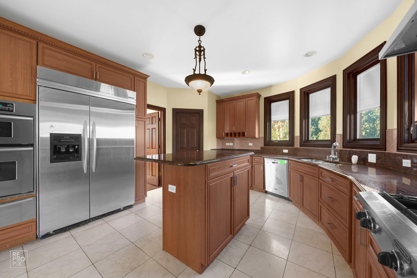916 Elmdale Road Glenview, IL 60025 - Photo 7 of 20 a large kitchen with stainless steel appliances granite countertop a refrigerator and a sink