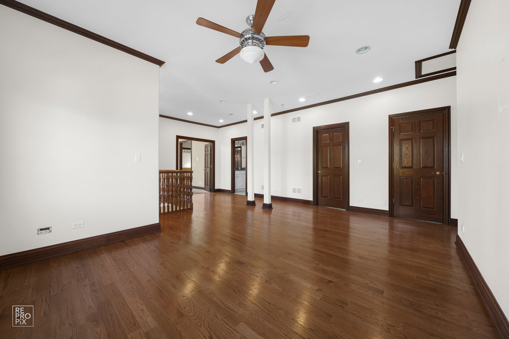 916 Elmdale Road Glenview, IL 60025 - Photo 8 of 20 a view of a livingroom with wooden floor and a ceiling fan