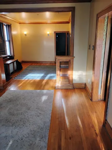 a view of a room with wooden floor