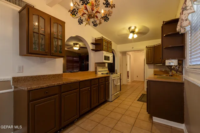 a kitchen with stainless steel appliances granite countertop a sink and cabinets