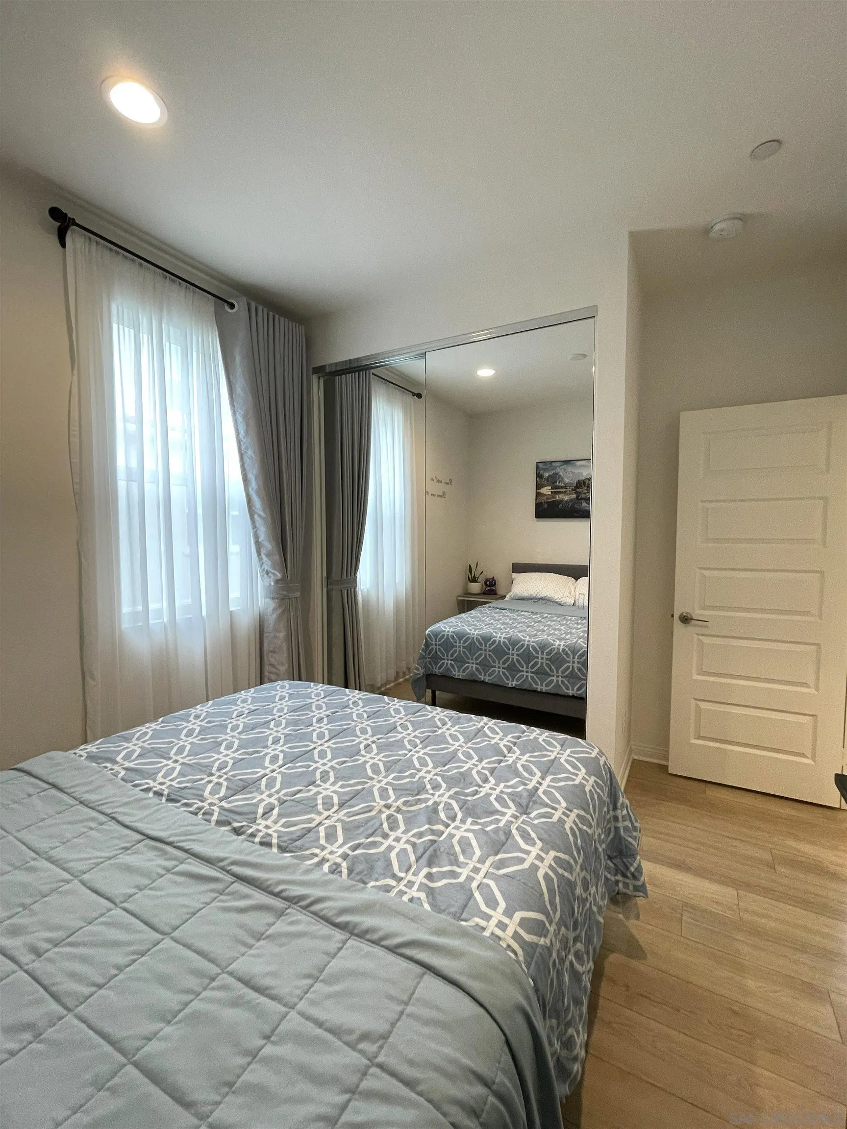 2708 Juniper Berry Street Spring Valley, CA 91977 - Photo 22 of 39 a bedroom with a large bed and wooden floor