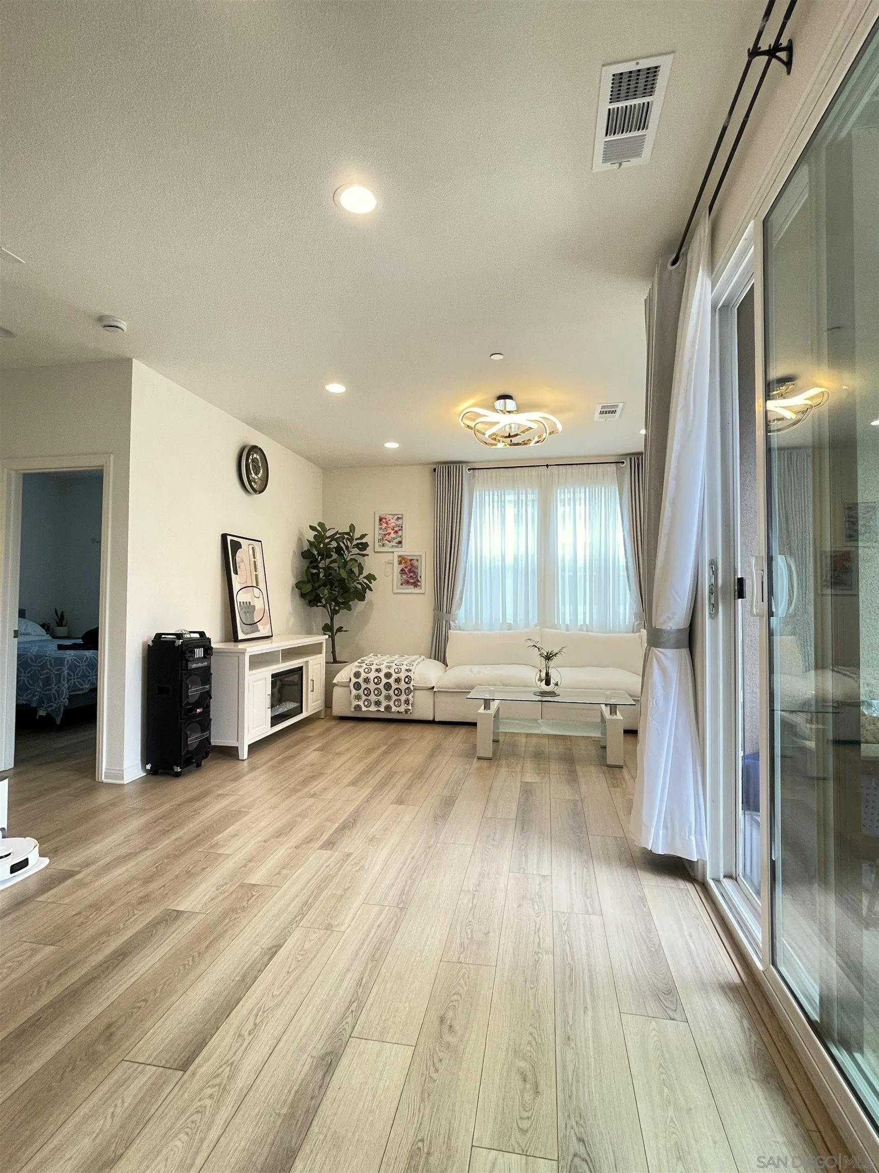 2708 Juniper Berry Street Spring Valley, CA 91977 - Photo 3 of 39 a view of a living room a hardwood floor and a ceiling fan