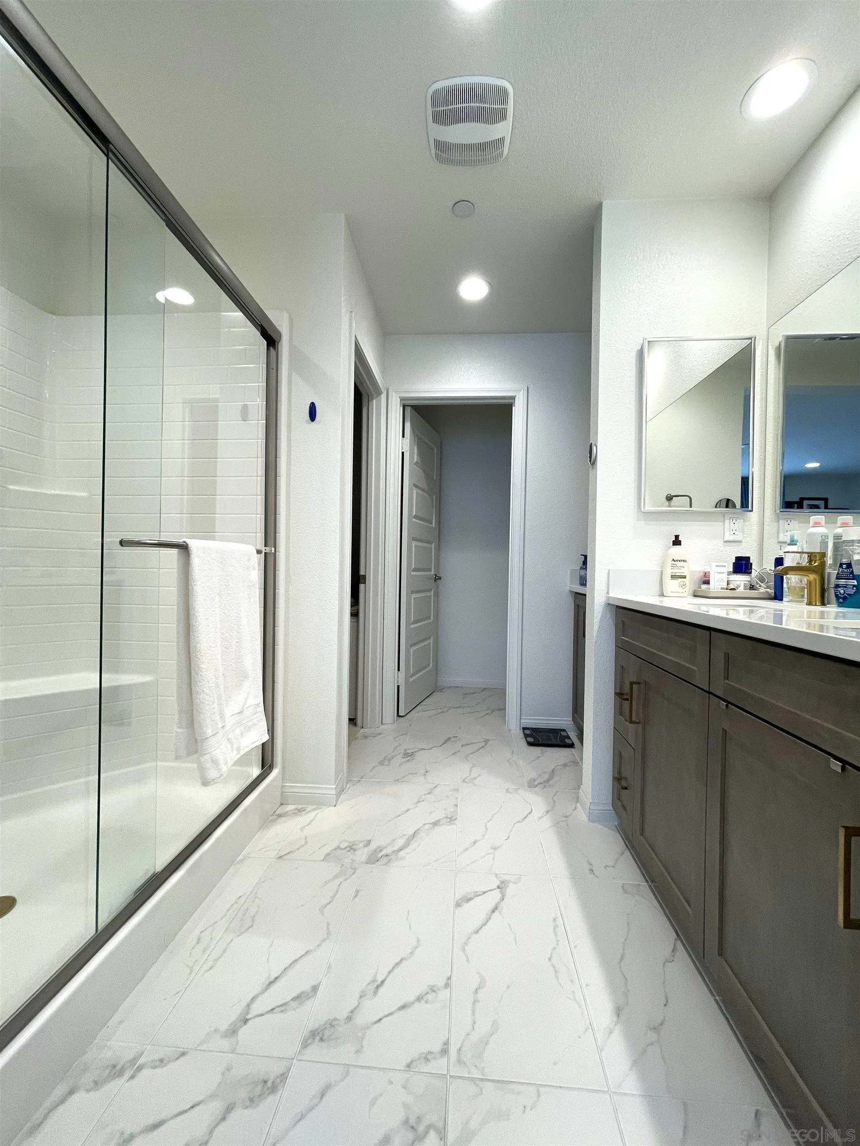 2708 Juniper Berry Street Spring Valley, CA 91977 - Photo 9 of 39 a bathroom with a double vanity sink and mirror