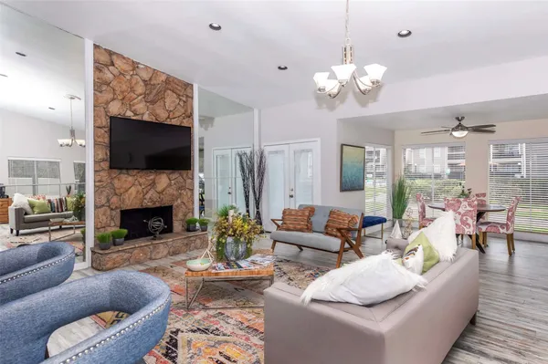 a living room with furniture a fireplace and a flat screen tv