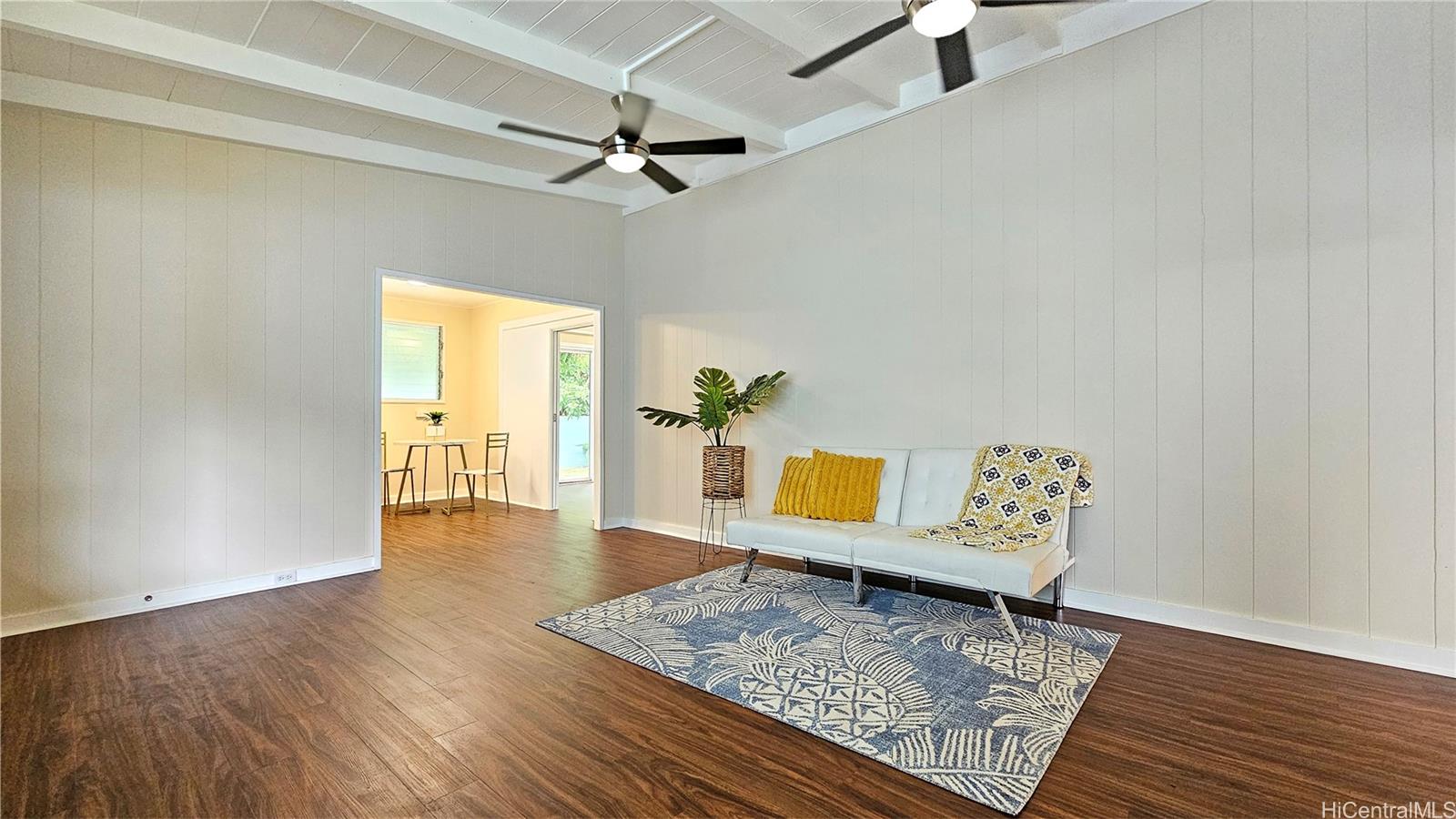 a living room with couch and wooden floor