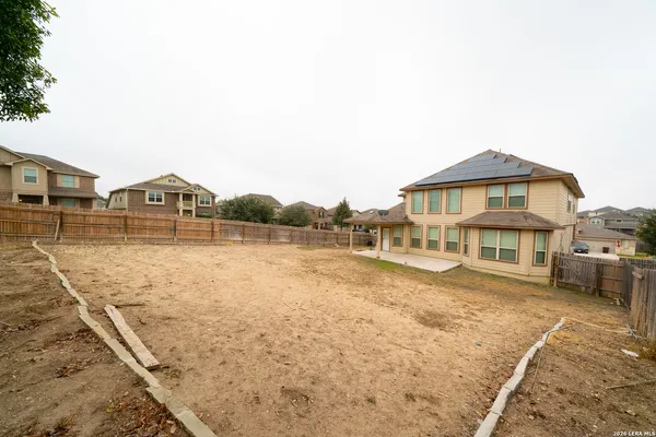 a view of a house next to a lake with a big yard