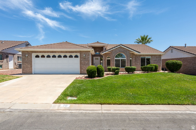 805 South River Road, Unit 70 St. George, UT 84790 - Photo 32 of 38 Brick exterior home featuring a two-car garage with arched window inserts