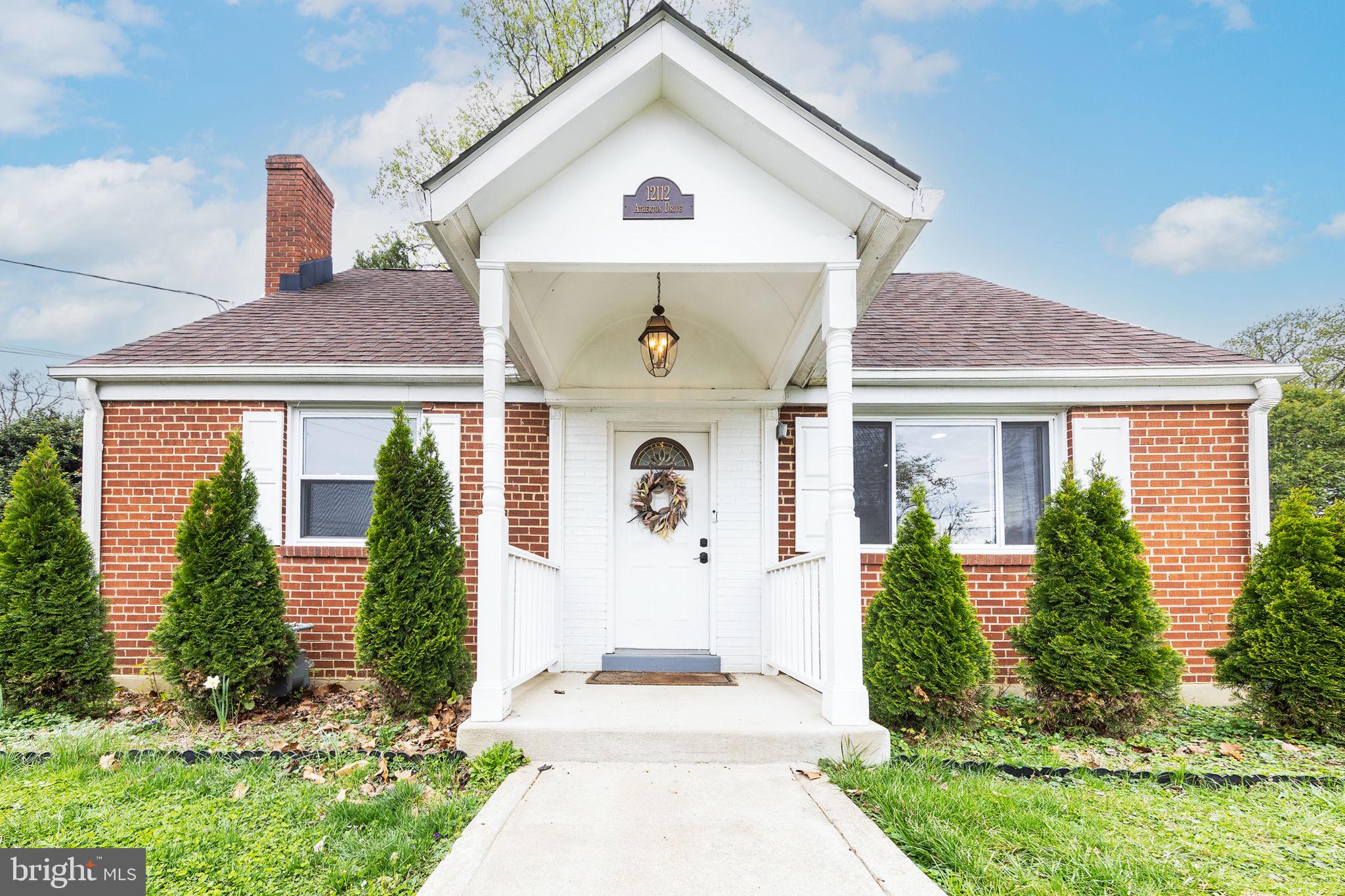 12112 Atherton Drive Silver Spring, MD 20902 - Photo 1 of 32 a front view of a house with garden