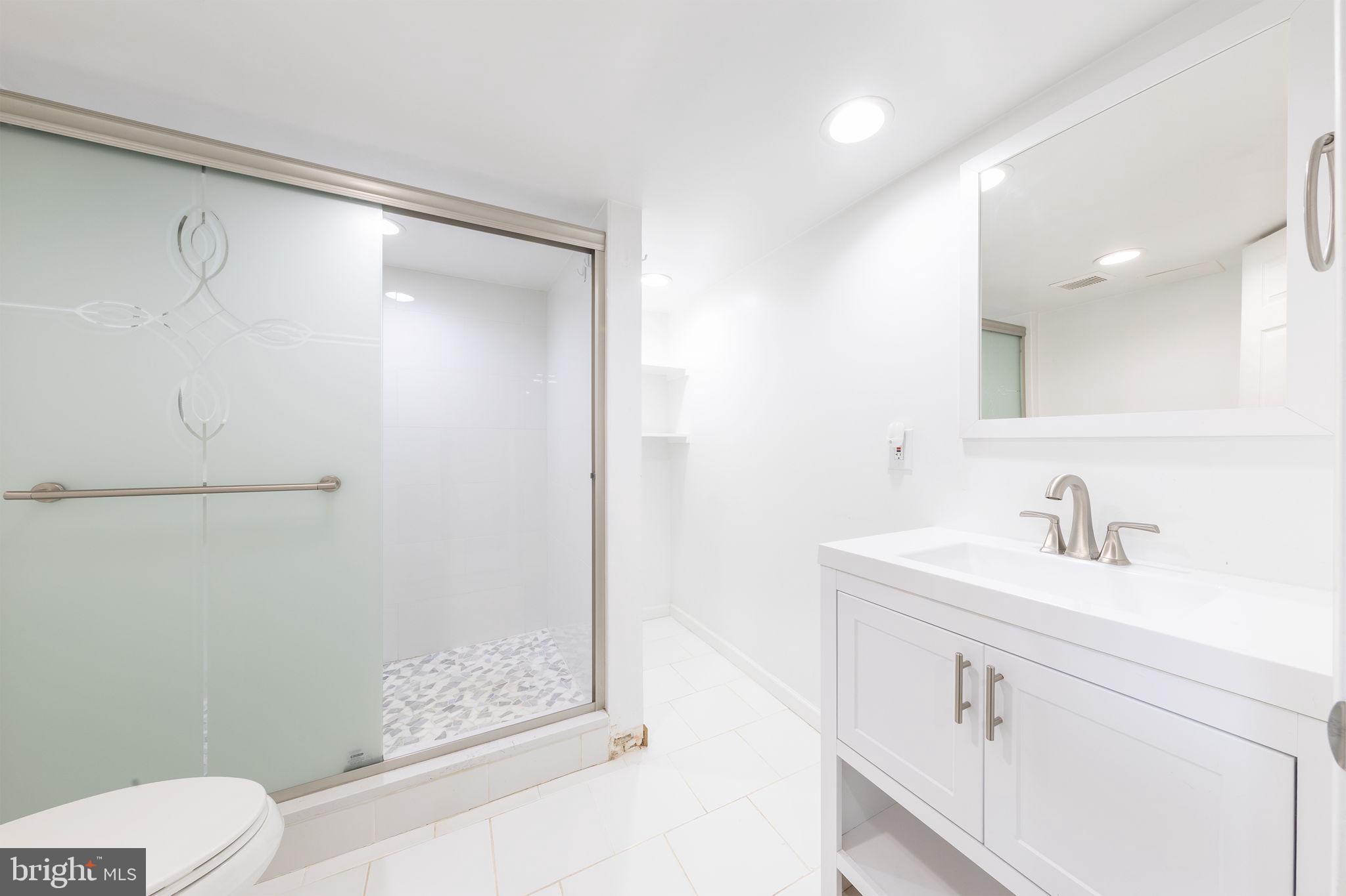 12112 Atherton Drive Silver Spring, MD 20902 - Photo 12 of 32 a bathroom with a sink toilet vanity and shower