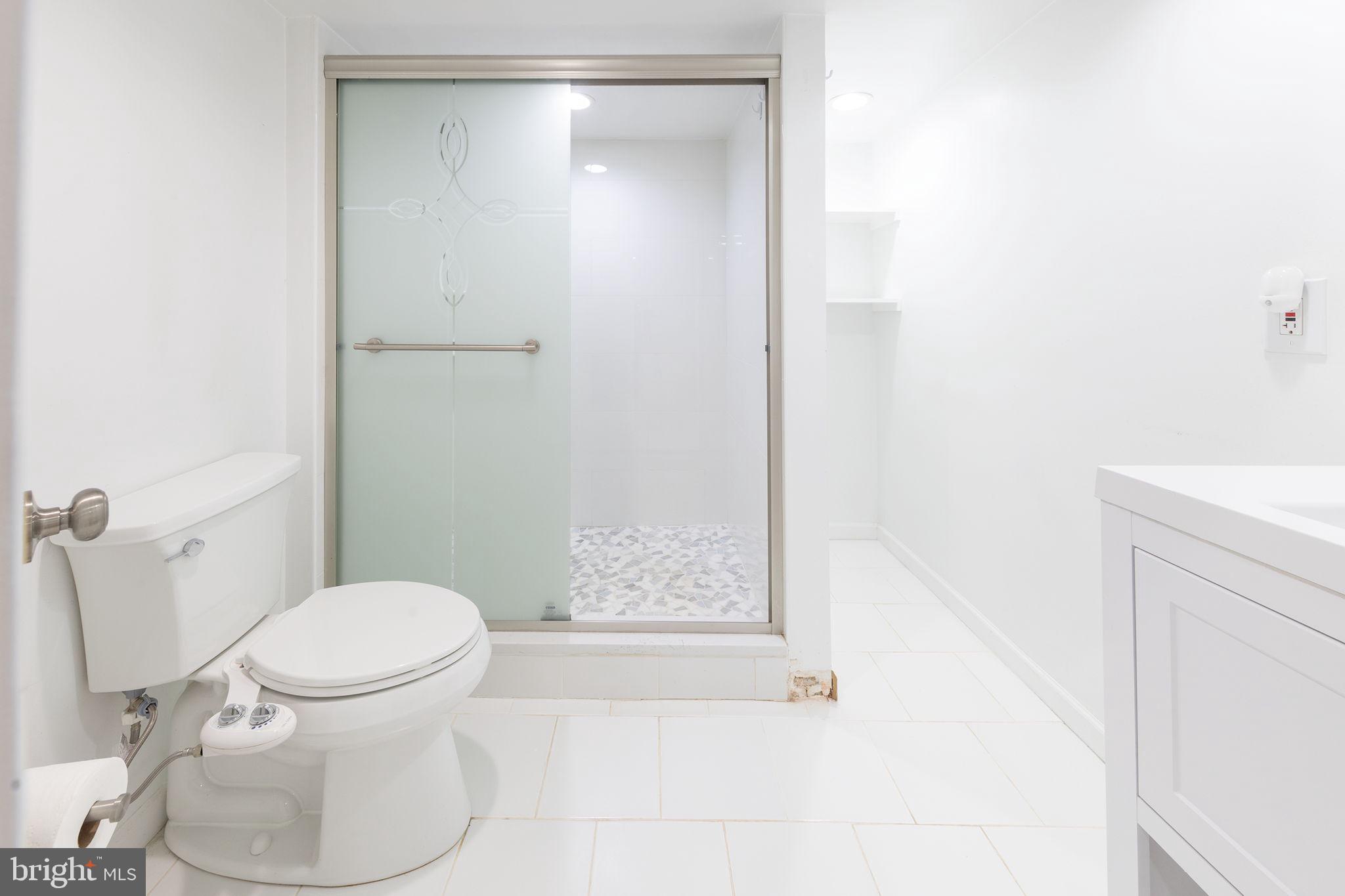 12112 Atherton Drive Silver Spring, MD 20902 - Photo 13 of 32 a white toilet sitting next to a bathroom sink