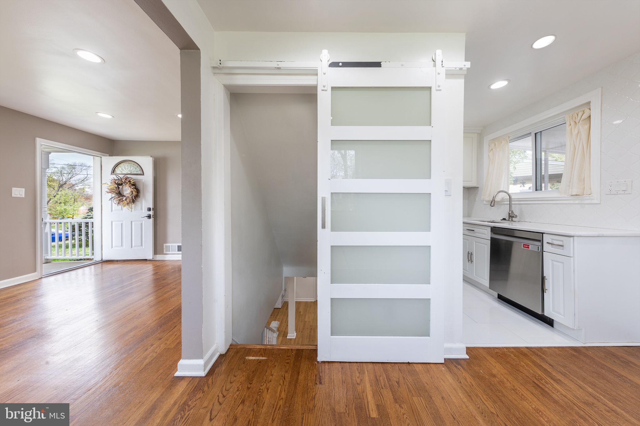 12112 Atherton Drive Silver Spring, MD 20902 - Photo 16 of 32 a view of an empty room with a window and wooden floor