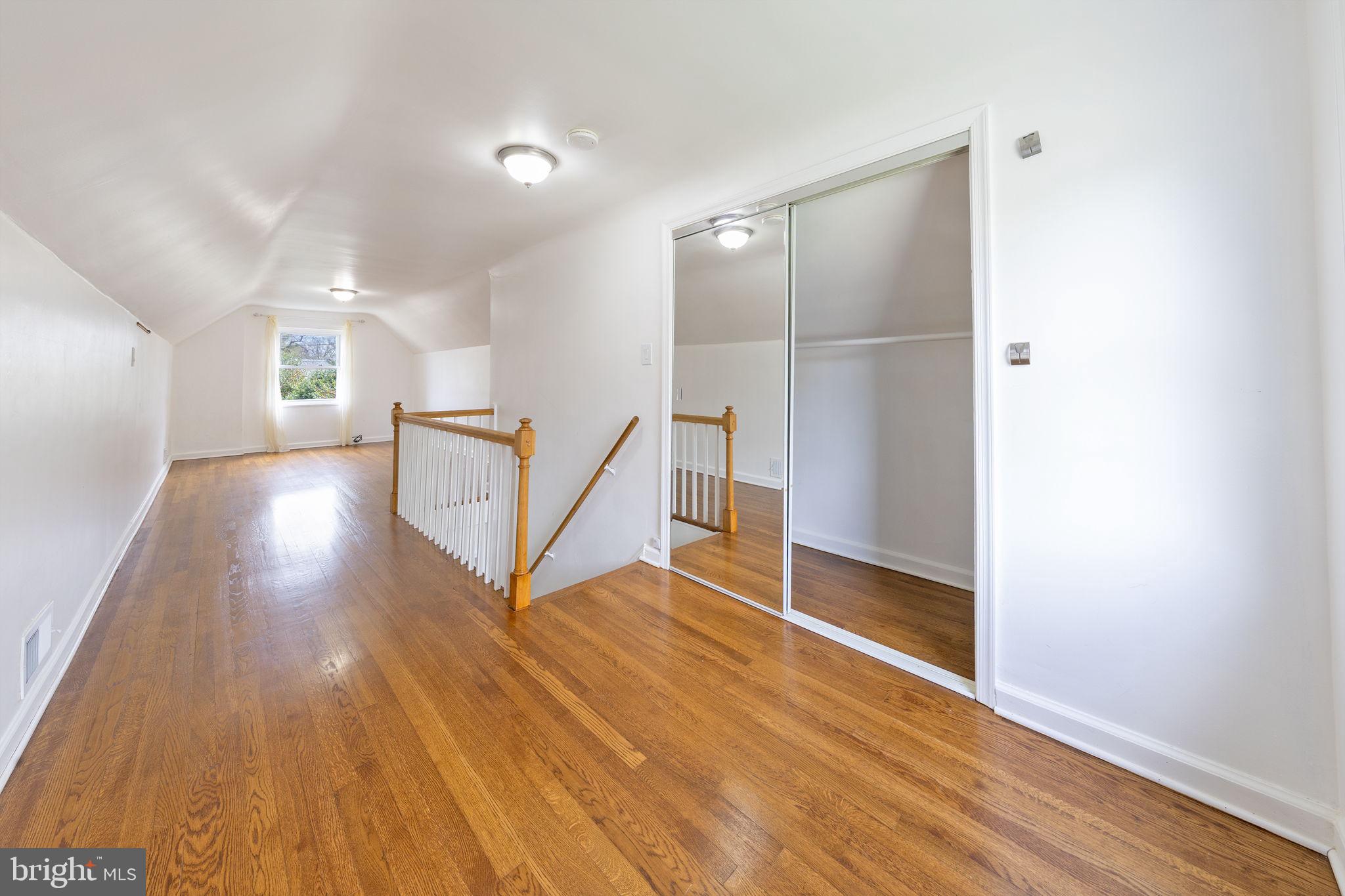 12112 Atherton Drive Silver Spring, MD 20902 - Photo 18 of 32 a view of a hallway with wooden floor and stairs