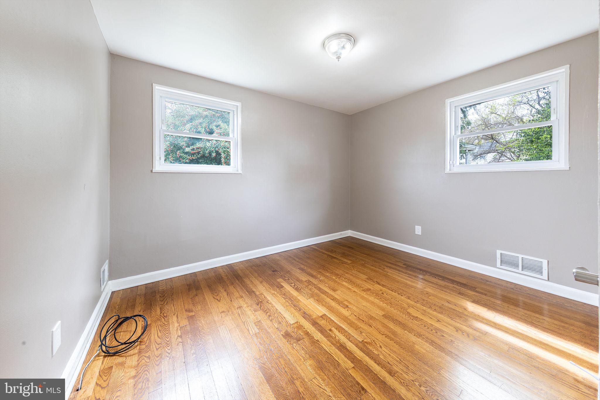 12112 Atherton Drive Silver Spring, MD 20902 - Photo 23 of 32 a view of empty room with wooden floor