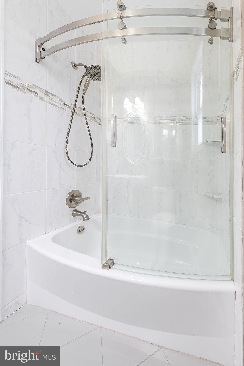 12112 Atherton Drive Silver Spring, MD 20902 - Photo 27 of 32 a bathroom with a shower and a bath tub