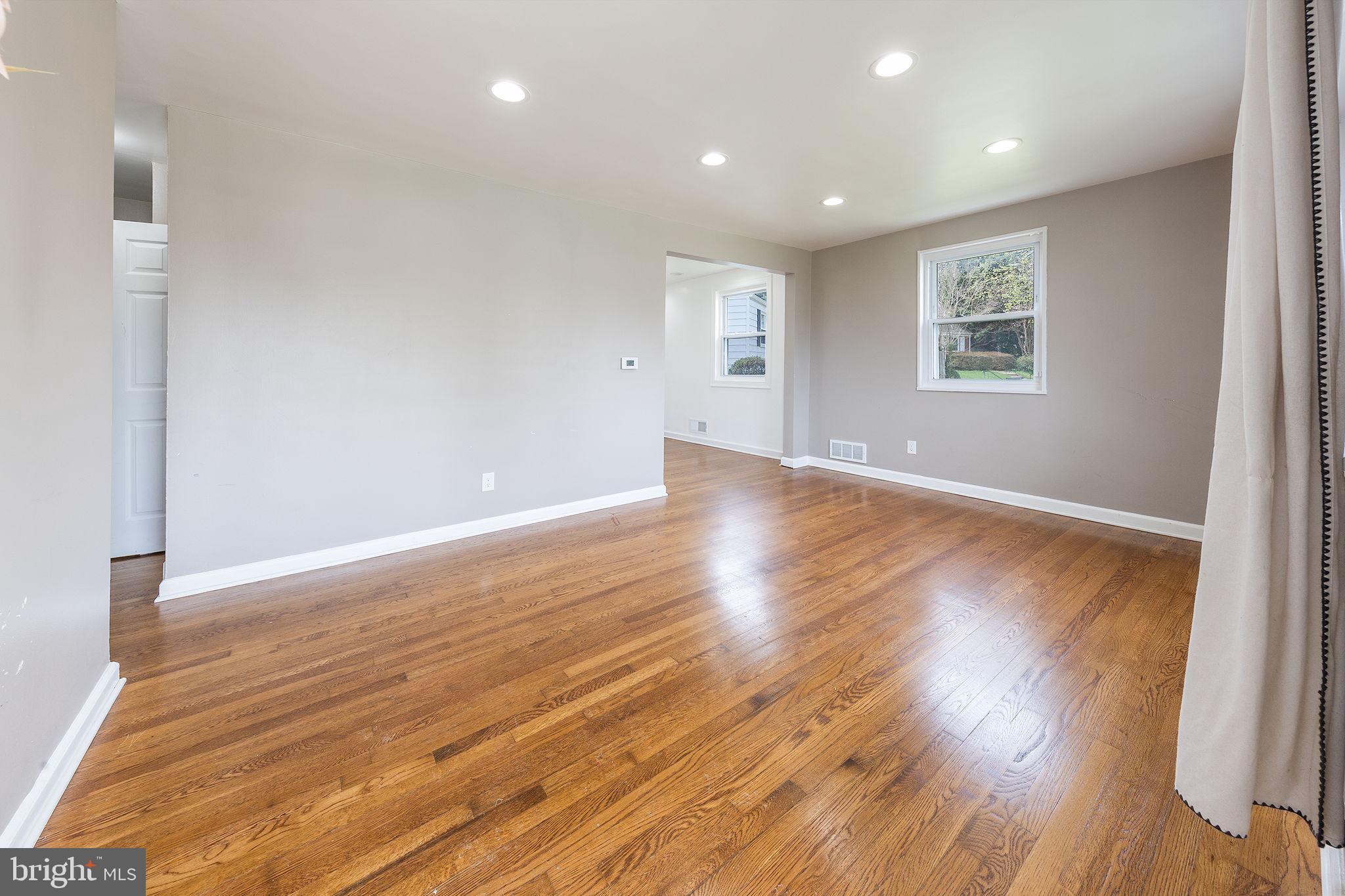 12112 Atherton Drive Silver Spring, MD 20902 - Photo 3 of 32 a view of an empty room with wooden floor and a window