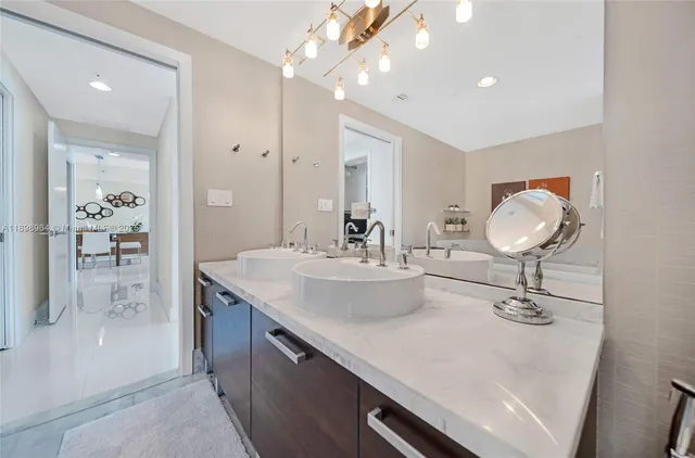 a bathroom with a sink double vanity and a mirror