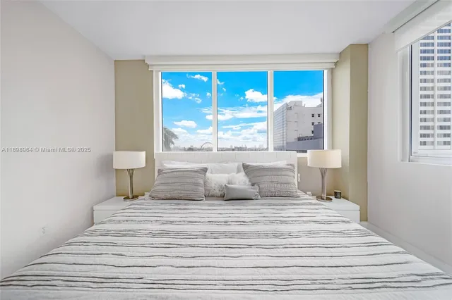 a bedroom with a large bed and a large window