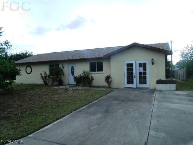 17476 Duquesne Road Fort Myers, FL 33967 - Photo 1 of 23 a front view of a house with garden