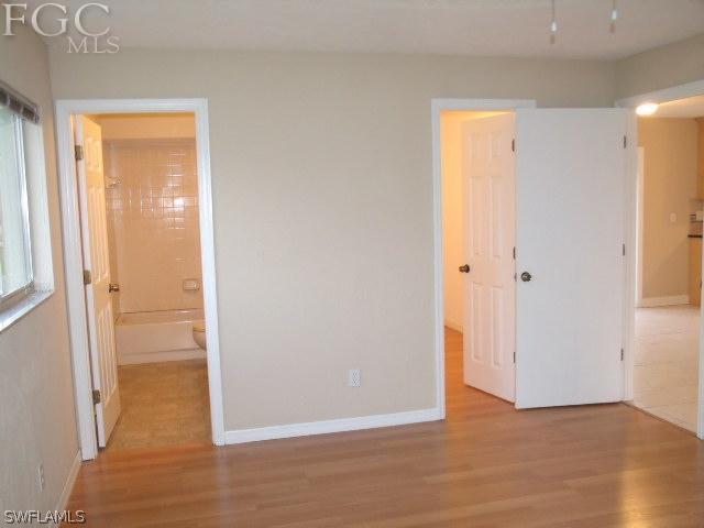 17476 Duquesne Road Fort Myers, FL 33967 - Photo 16 of 23 an empty room with wooden floor and a window