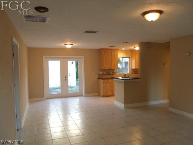 17476 Duquesne Road Fort Myers, FL 33967 - Photo 4 of 23 a view of open kitchen with granite countertop cabinets and stainless steel appliances