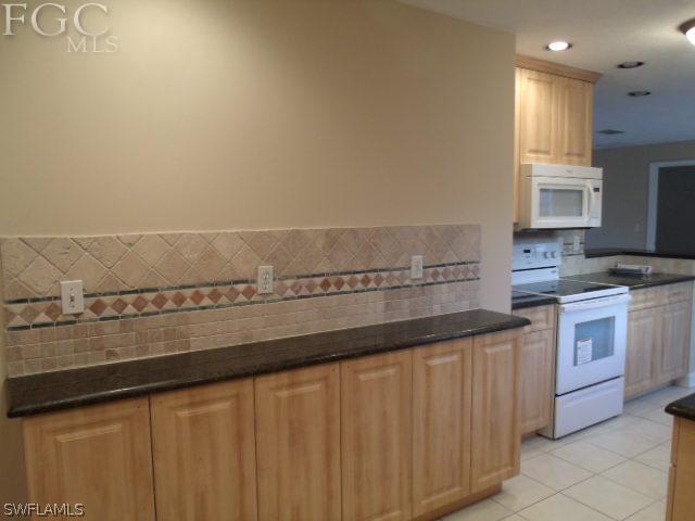 17476 Duquesne Road Fort Myers, FL 33967 - Photo 9 of 23 a kitchen with a sink and cabinets