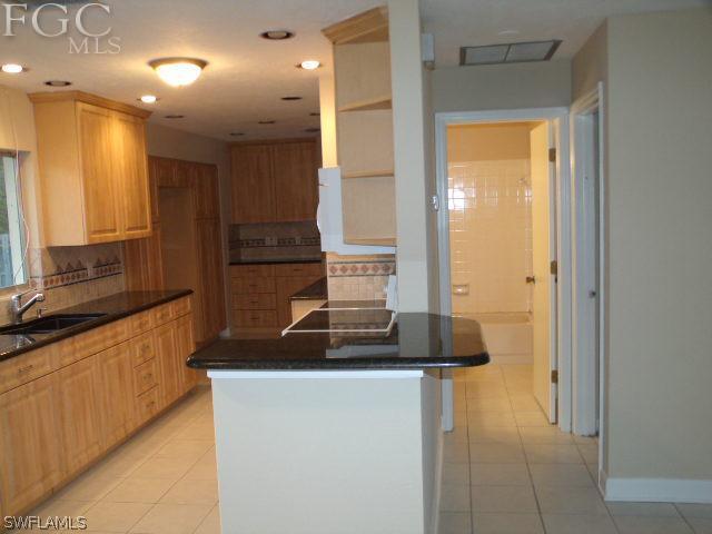 17476 Duquesne Road Fort Myers, FL 33967 - Photo 10 of 23 a kitchen with stainless steel appliances granite countertop a sink and a refrigerator