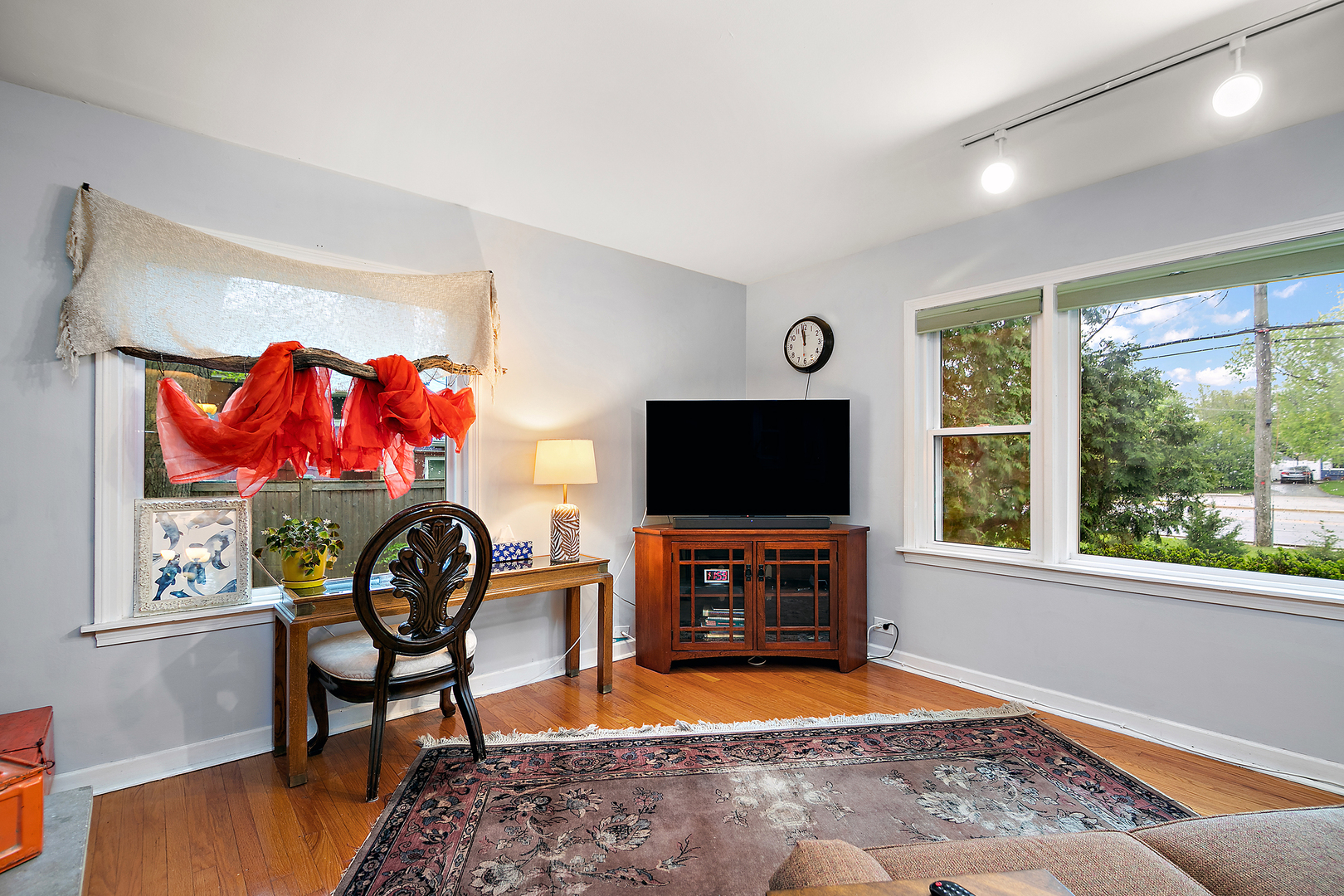2444 183rd Street Homewood, IL 60430 - Photo 7 of 25 a living room with furniture a flat screen tv and a large window