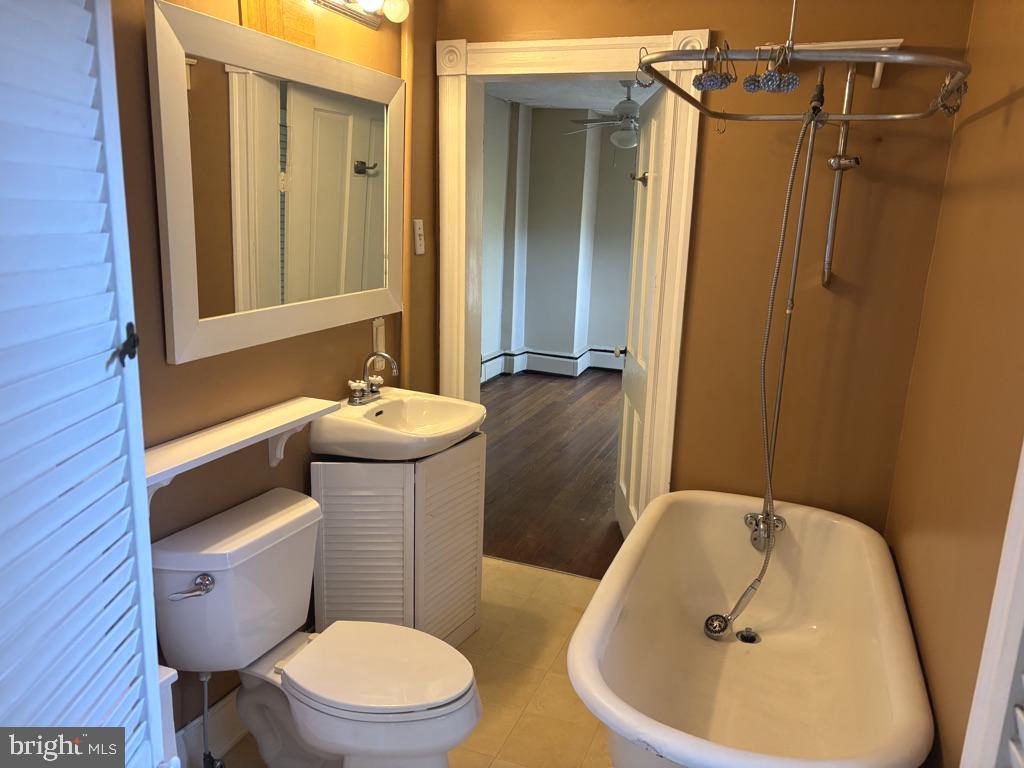 121 East 4th Street Frederick, MD 21701 - Photo 12 of 21 a bathroom with a sink and mirror with toilet