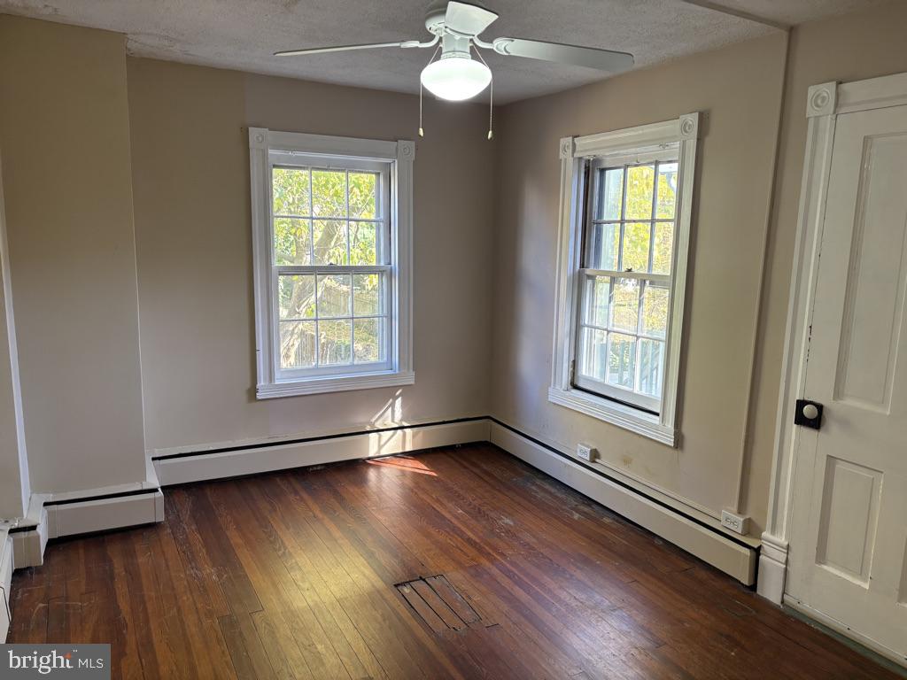 121 East 4th Street Frederick, MD 21701 - Photo 14 of 21 a view of an empty room with wooden floor and a window