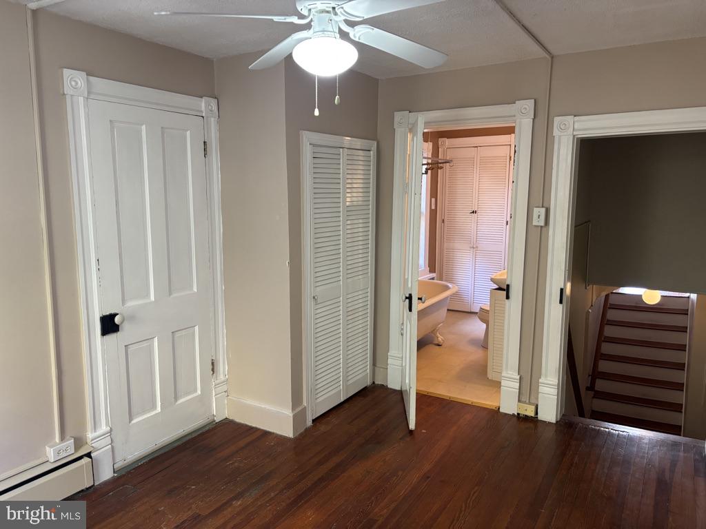 121 East 4th Street Frederick, MD 21701 - Photo 15 of 21 a view of a hallway with wooden floor and staircase